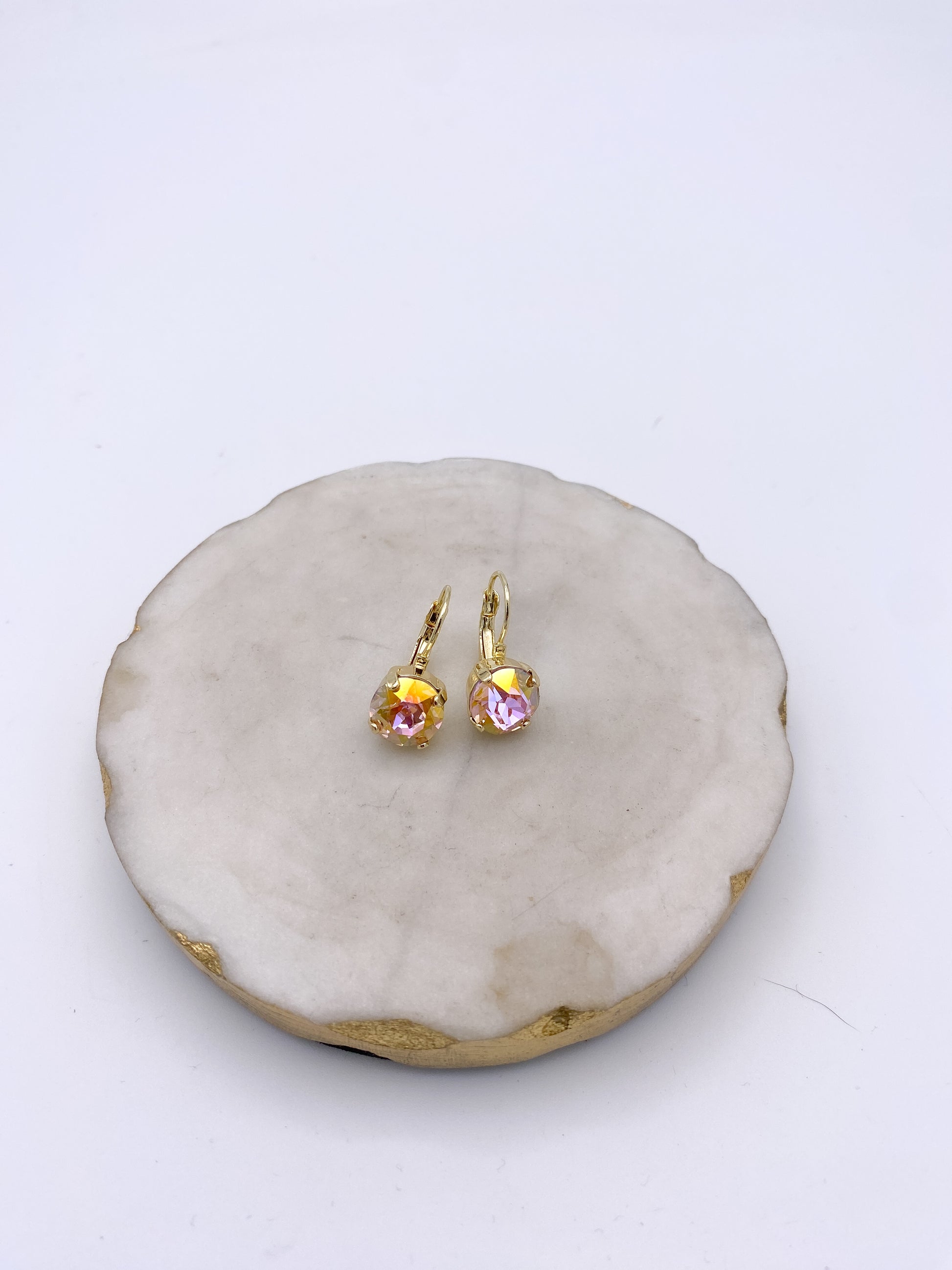 Gold lever-back drop earrings with faceted blush pink iridescent crystal stones in prong settings