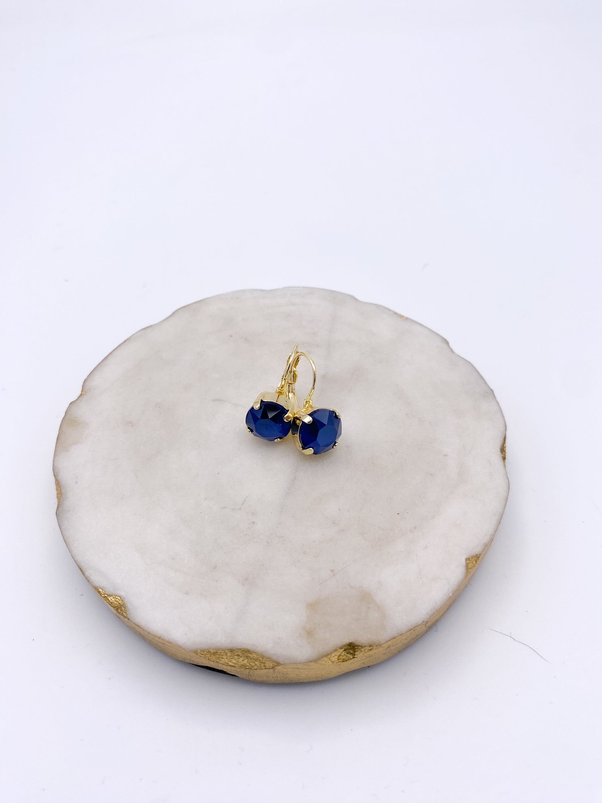 Gold lever-back drop earrings with deep sapphire blue oval faceted stones by AF Designs