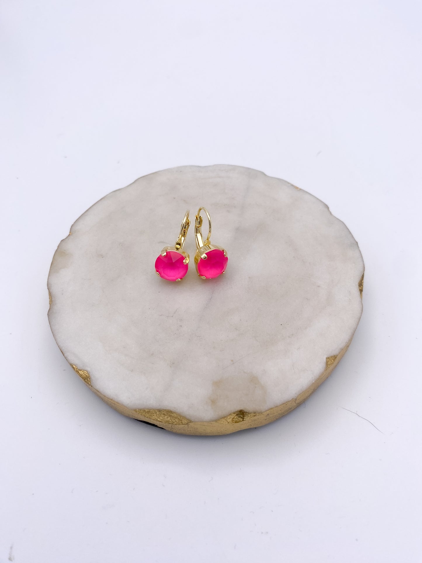 Gold lever-back drop earrings with vibrant electric pink faceted round gemstone settings by AF Designs.
