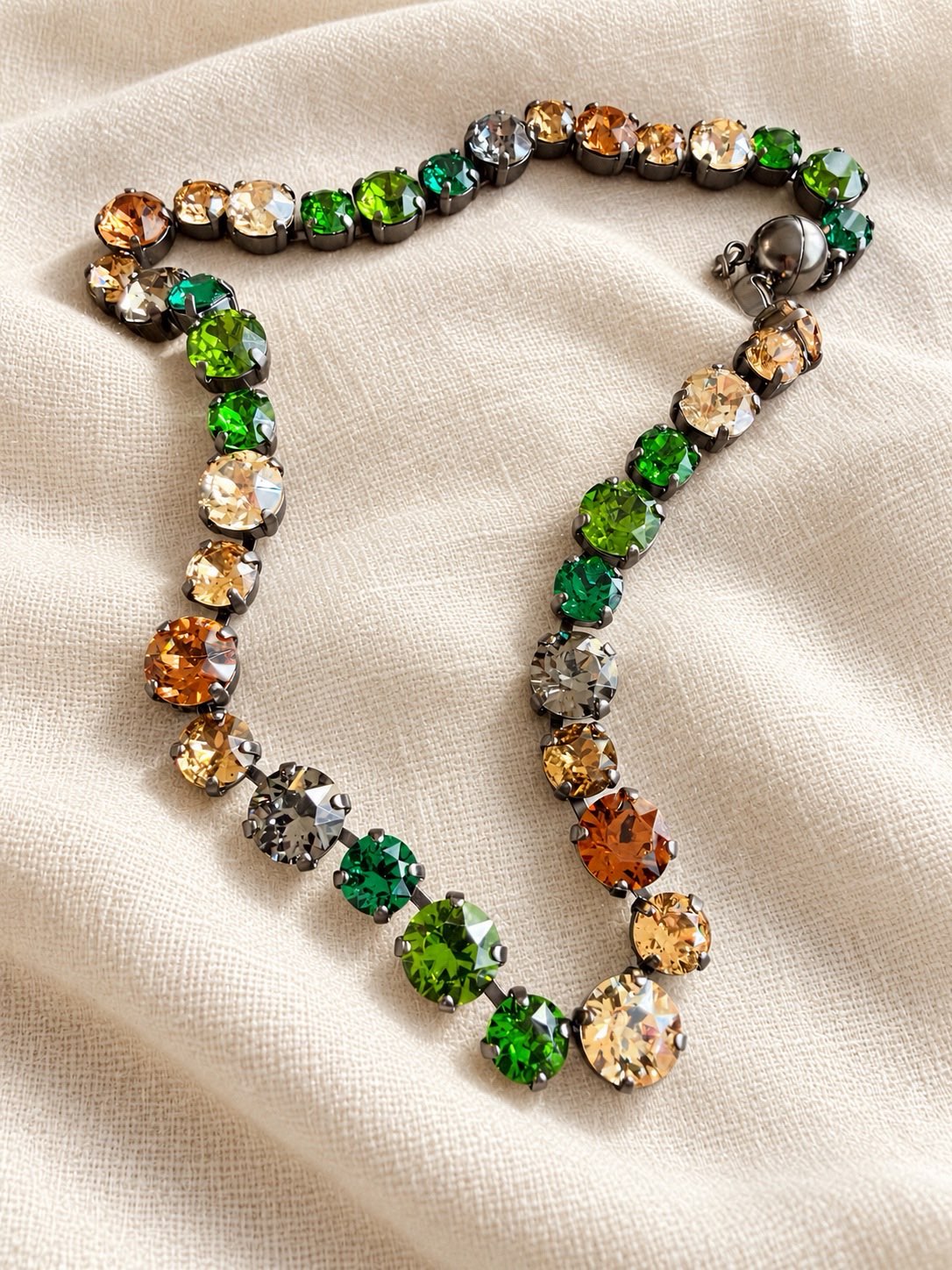 AF Designs crystal tennis necklace with green, amber, orange & gray stones in gunmetal settings