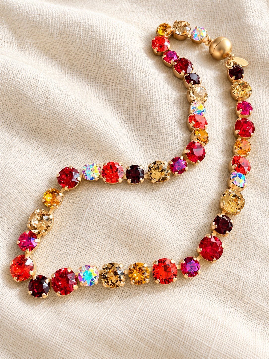 AF Designs tennis necklace with multicolor red, pink, amber & gold crystals in gold prong settings, warm pomegranate palette