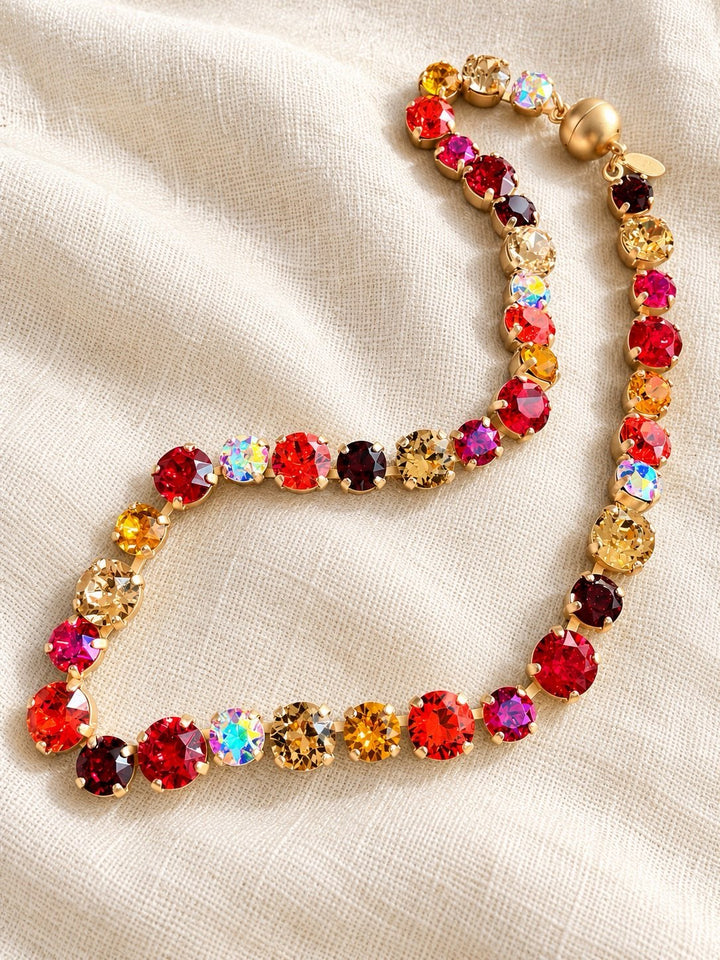 AF Designs tennis necklace with multicolor red, pink, amber & gold crystals in gold prong settings, warm pomegranate palette
