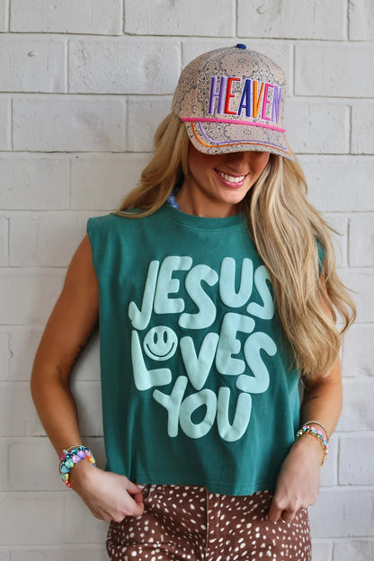 Smiley Jesus Loves You Puff Tank in teal on model, front view, crew neck, sleeveless, light aqua smiley face lettering