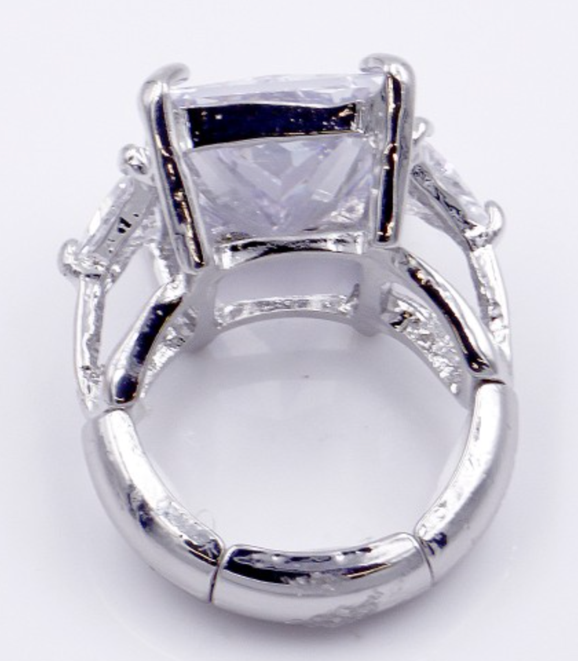 Rhodium plated stretch ring with large clear rectangular crystal stone and ornate metalwork details