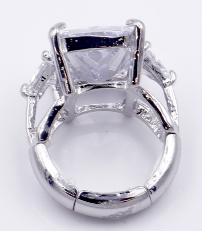 Rhodium plated stretch ring with large clear rectangular crystal stone and ornate metalwork details