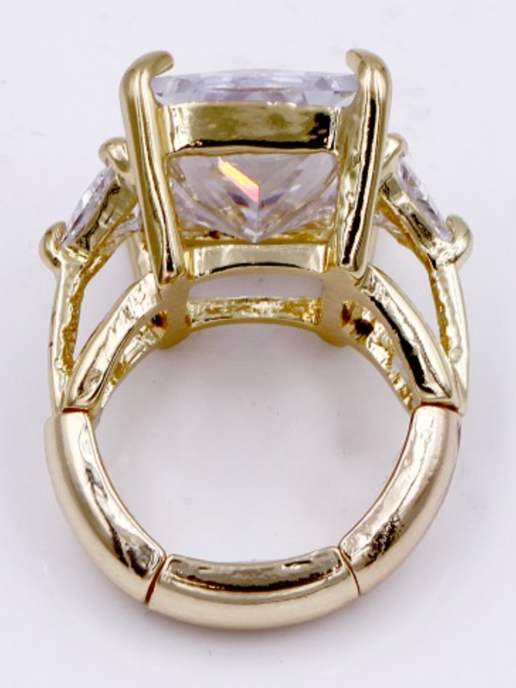 Gold plated stretch ring with large square clear crystal center stone and smaller side stones