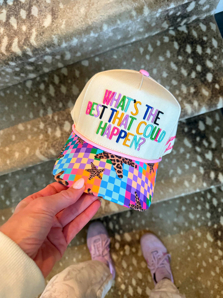 White trucker hat with rainbow embroidered positive quote and colorful checkerboard leopard-star print brim