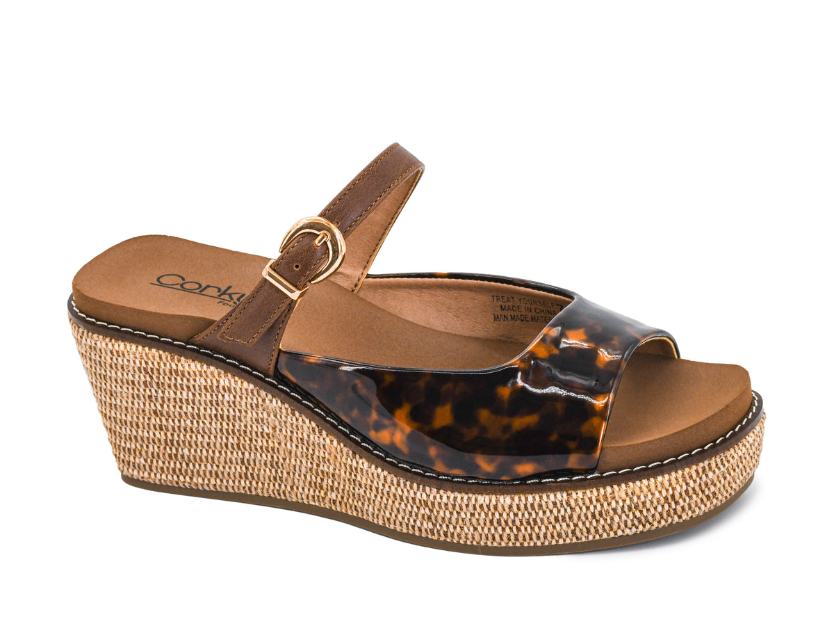 Corkys women's tortoiseshell wedge sandal with raffia platform, gold buckle ankle strap, and cushioned footbed.
