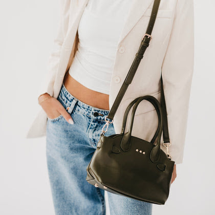 Pretty Simple Veronica Small Tote in olive green with rose gold studs and crossbody strap, worn over casual outfit