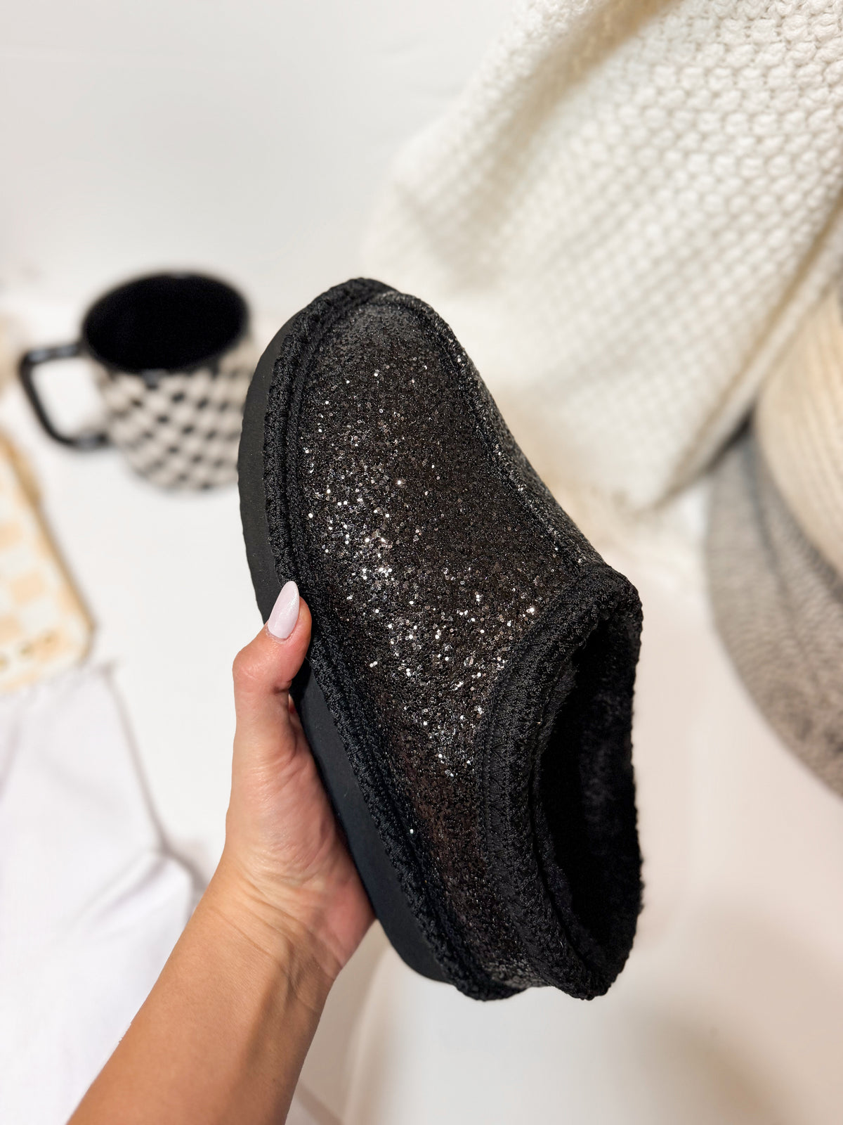 Very G black ultra-mini slip-on boot with all-over glitter sequins, sherpa lining, and thick black platform sole.