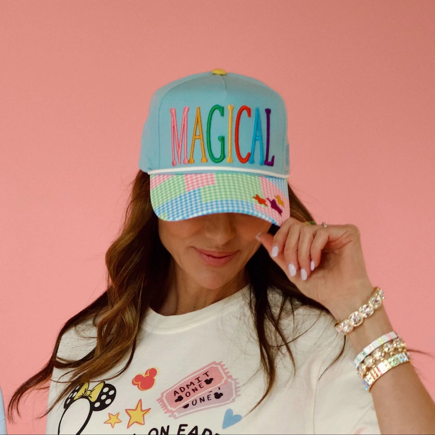 Light blue trucker hat with rainbow 'MAGICAL' embroidery and pastel patchwork gingham brim with star accents
