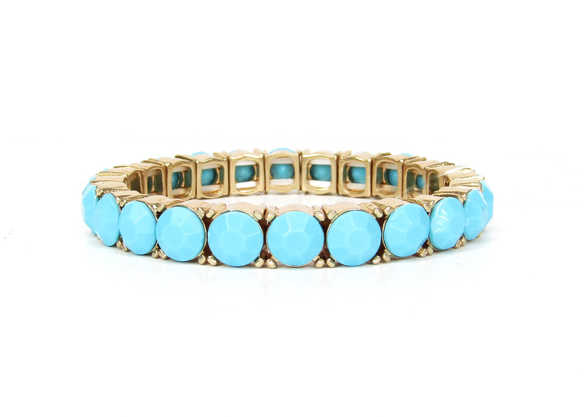 Turquoise and gold tennis bracelet with round cabochon stones in bezel settings