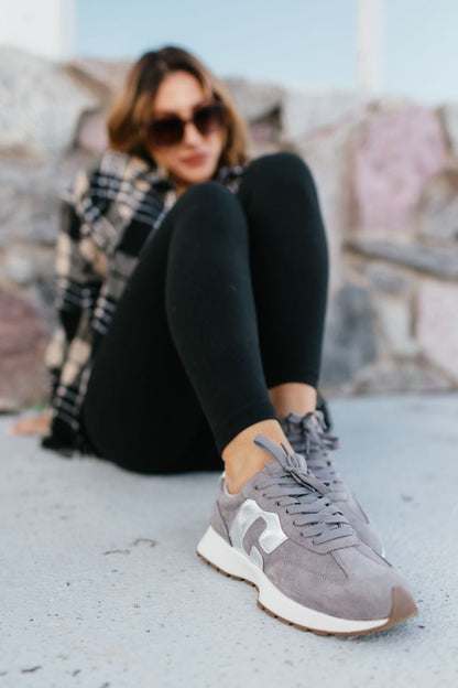 Corky's Grey Faux Suede No Prob Sneakers worn with black leggings, lace-up retro runner with white sole