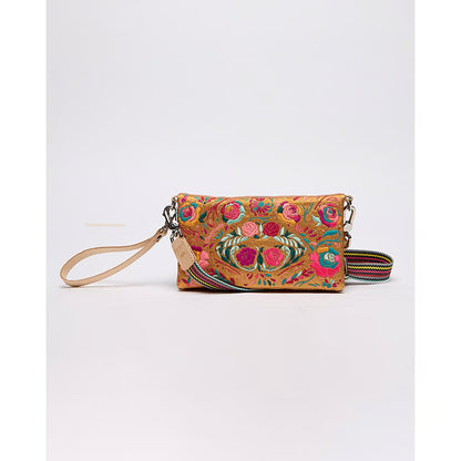 Consuela Uptown Crossbody in Bronzer with colorful floral embroidery, leather wrist strap, and striped crossbody strap.
