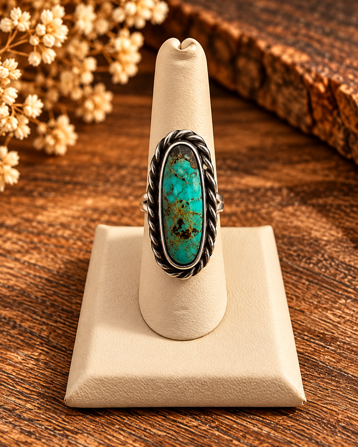 Desert Daisy Ring by Boho Sol, a long oval blue-green turquoise stone with golden veining in a twisted rope sterling setting